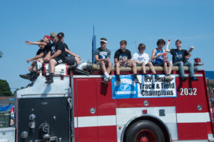 Ishpemings Track and Field team road on one of the fire trucks.