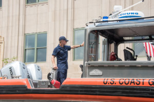 Waving from the Coast Guard boat.