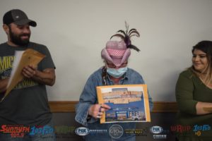 Elizabeth holds up her "golden ticket".
