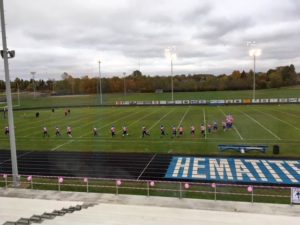 The team warms up in their pink uniforms.