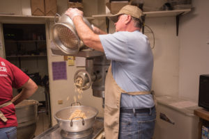 John working in the back making some fresh pasty ingredients.